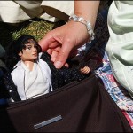 A woman shows off her Michael Jackson doll