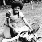 MICHAEL JACKSON playing with his pet Alsatian Winston in 1973