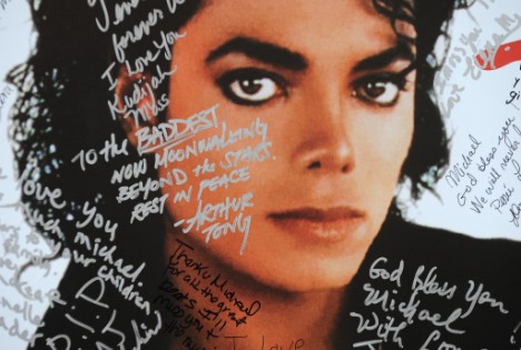 A poster of Michael Jackson is covered with messages from fans at a one-day tribute to the 