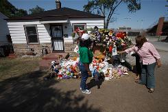 Cheryle Grace, right, and Valerie Grace visit the growing memorial at Michael Jackson's childhood home in Gary, Ind., at 2300 Jackson St.